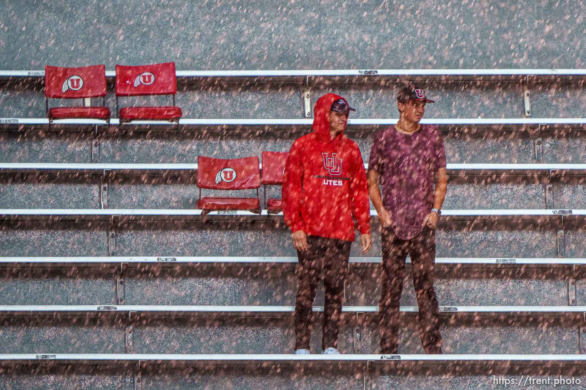 (Trent Nelson  |  The Salt Lake Tribune) Rain pours down on fans during a lightning delay as the Utah Utes host the Weber State Wildcats in Salt Lake City on Thursday, Sept. 2, 2021.