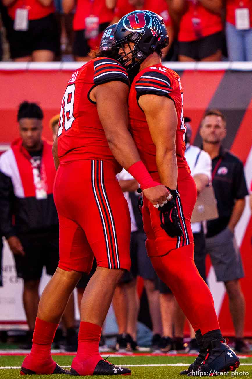 (Trent Nelson  |  The Salt Lake Tribune) Utah Utes defensive tackle Viane Moala (98) and Utah Utes defensive end Mika Tafua (42) celebrate a sack as the Utah Utes host the Weber State Wildcats in Salt Lake City on Thursday, Sept. 2, 2021.