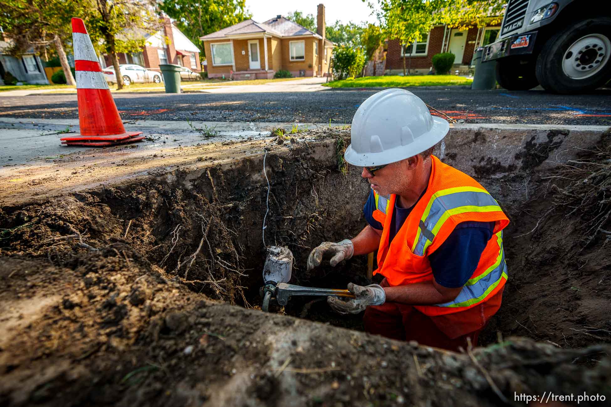 (Trent Nelson  |  The Salt Lake Tribune) Dustin Whitaker at work as a leaking water connection is replaced by a public utilities crew in Salt Lake City on Thursday, Sept. 9, 2021.