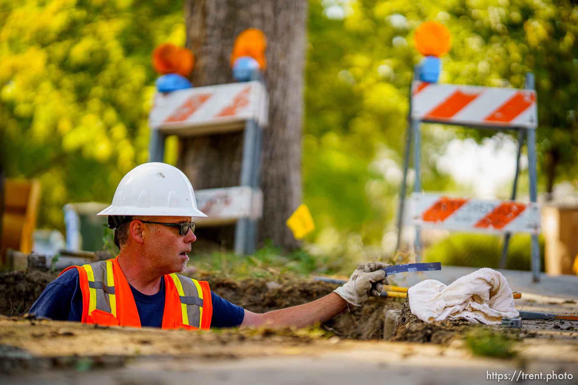 (Trent Nelson  |  The Salt Lake Tribune) Dustin Whitaker at work as a leaking water connection is replaced by a public utilities crew in Salt Lake City on Thursday, Sept. 9, 2021.