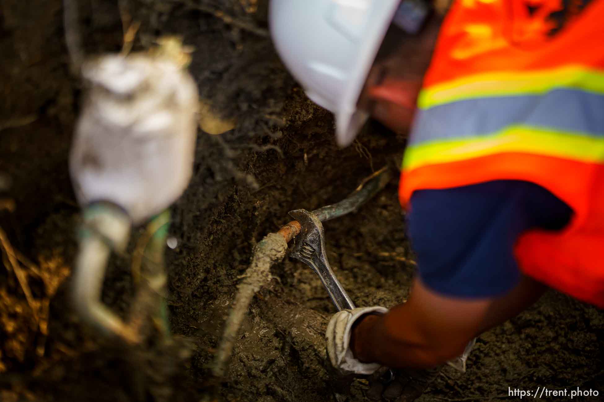 (Trent Nelson  |  The Salt Lake Tribune) Dustin Whitaker at work as a leaking water connection is replaced by a public utilities crew in Salt Lake City on Thursday, Sept. 9, 2021.