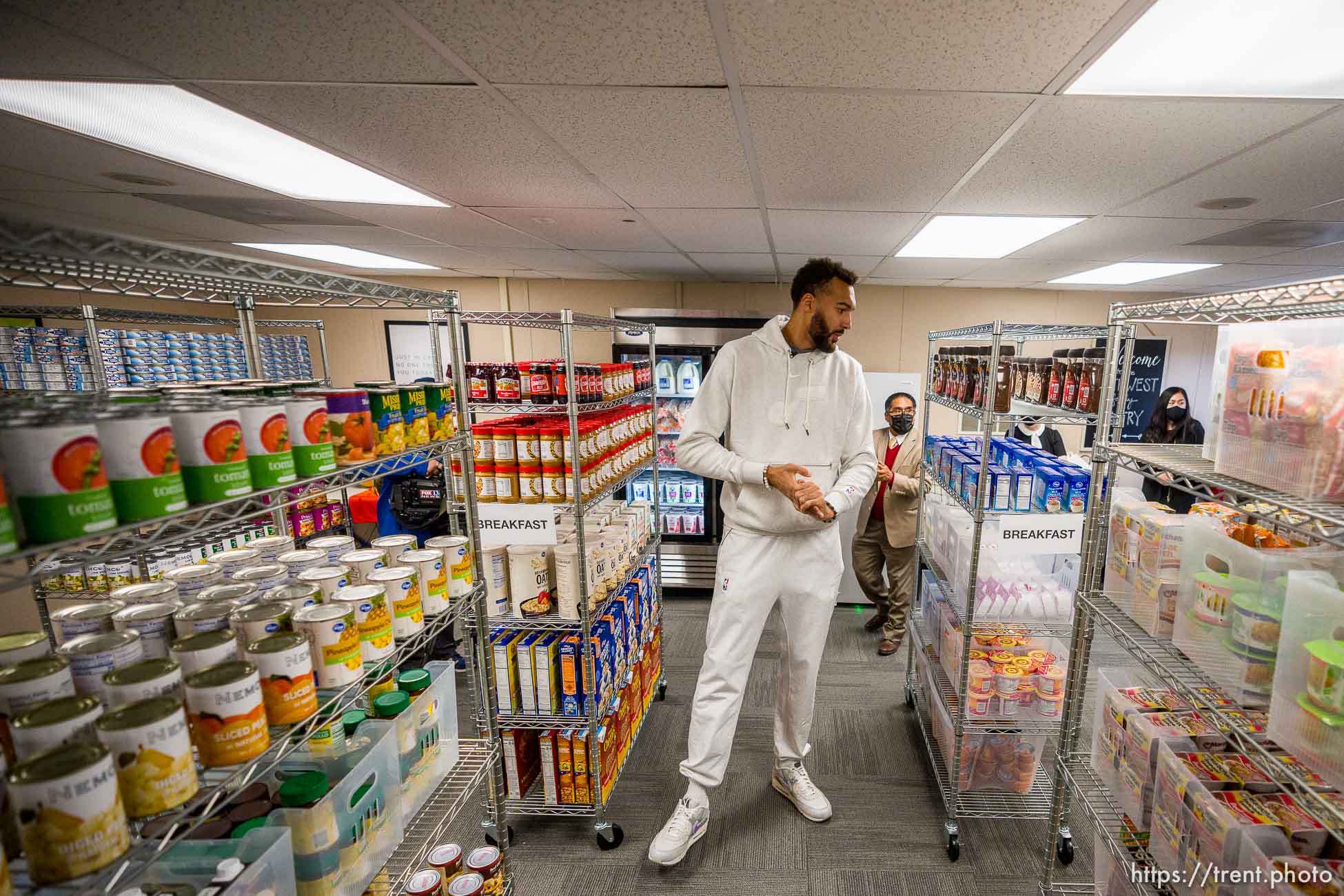 (Trent Nelson  |  The Salt Lake Tribune) Utah Jazz center Rudy Gobert visits Northwest Middle School to see the new food pantry, in Salt Lake City on Thursday, Oct. 14, 2021. Rudy's Kids Foundation, Smith's Food and the Salt Lake Education Foundation combined efforts to open the food pantry. At rear is James Yapias of the Salt Lake Education Foundation.