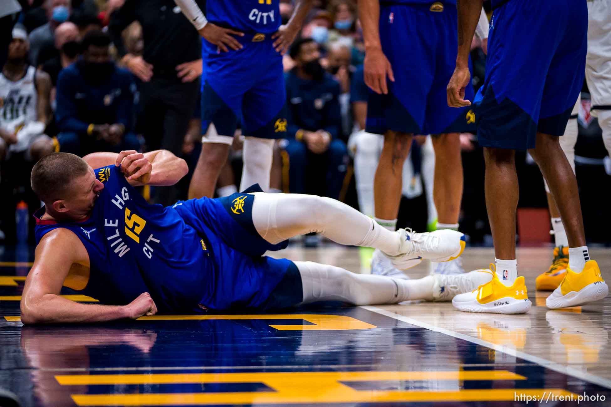 (Trent Nelson  |  The Salt Lake Tribune) Denver Nuggets center Nikola Jokic (15) in pain and on the court immediately before leaving the game, as the Utah Jazz host the Denver Nuggets, NBA basketball in Salt Lake City on Tuesday, Oct. 26, 2021.