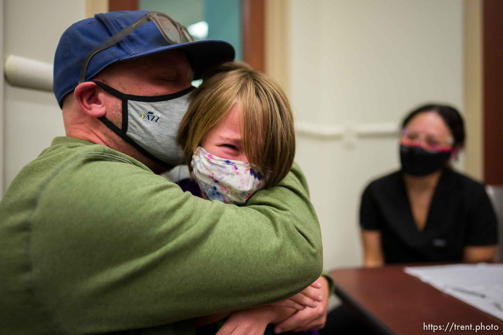 (Trent Nelson  |  The Salt Lake Tribune) Jason Miller holds his daughter, Teagan, after she was vaccinated against COVID-19 by Tenzin Drongsar at South Main Public Health Center in South Salt Lake on Wednesday, Nov. 3, 2021.