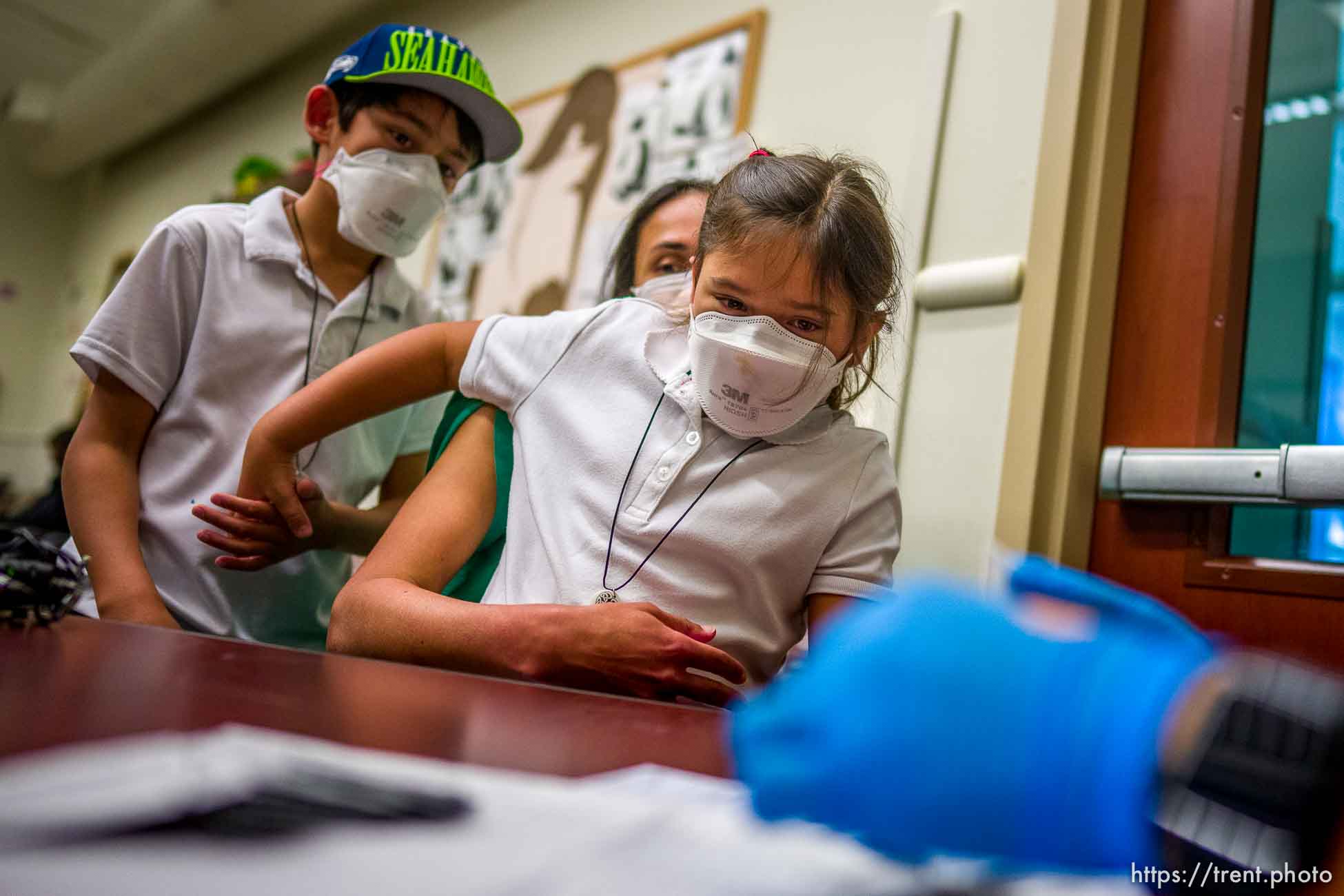 Arya Martinez holds her brother Kirav's hand as she is vaccinated against COVID-19 by Tenzin Drongsar at South Main Public Health Center in South Salt Lake on Wednesday, Nov. 3, 2021.