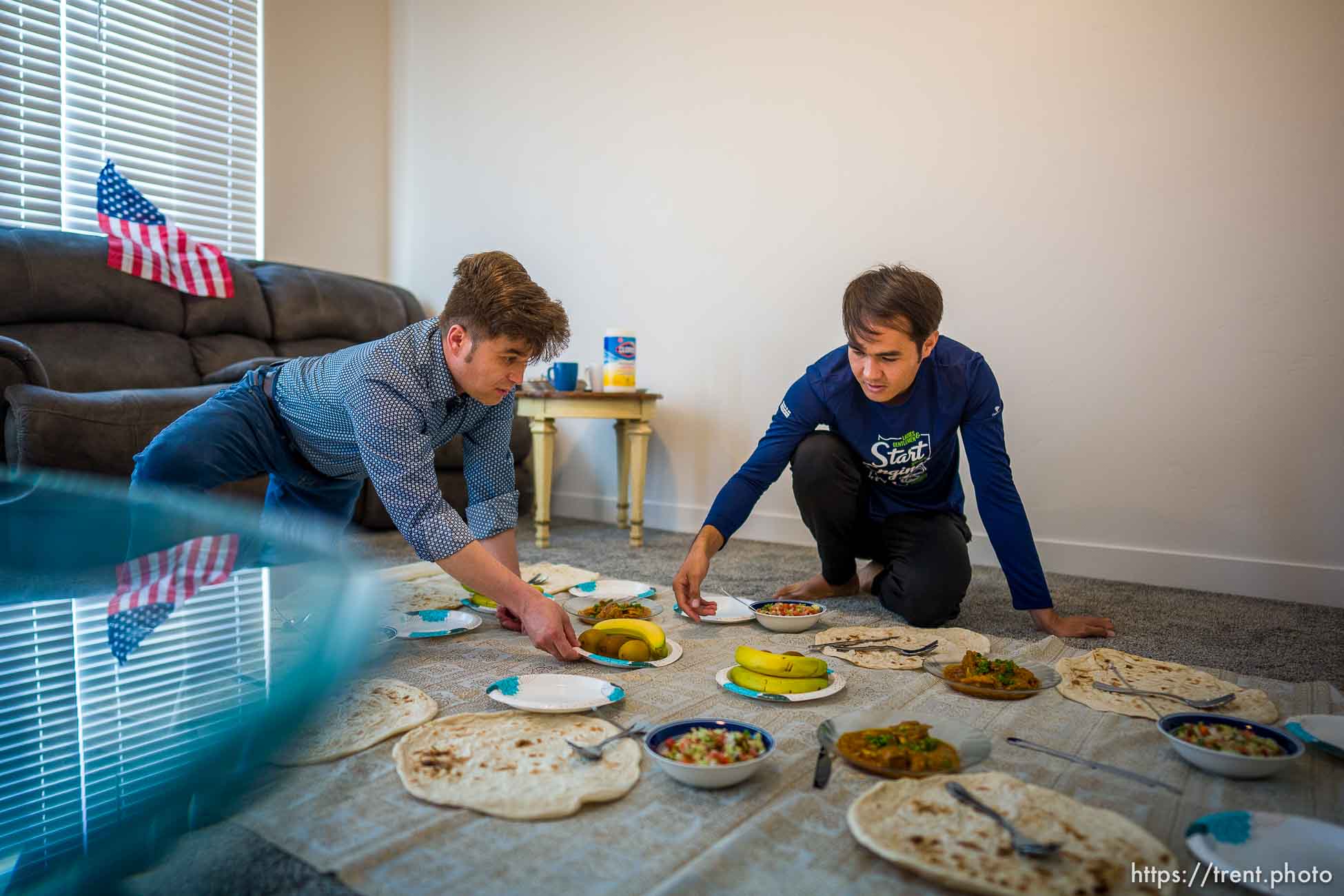 (Trent Nelson  |  The Salt Lake Tribune) Azim Kakaie and Arif Muradi set out lunch in their North Salt Lake home on Friday, Nov. 5, 2021. Some members of the family recently moved to Utah from Afghanistan, while others remain behind.