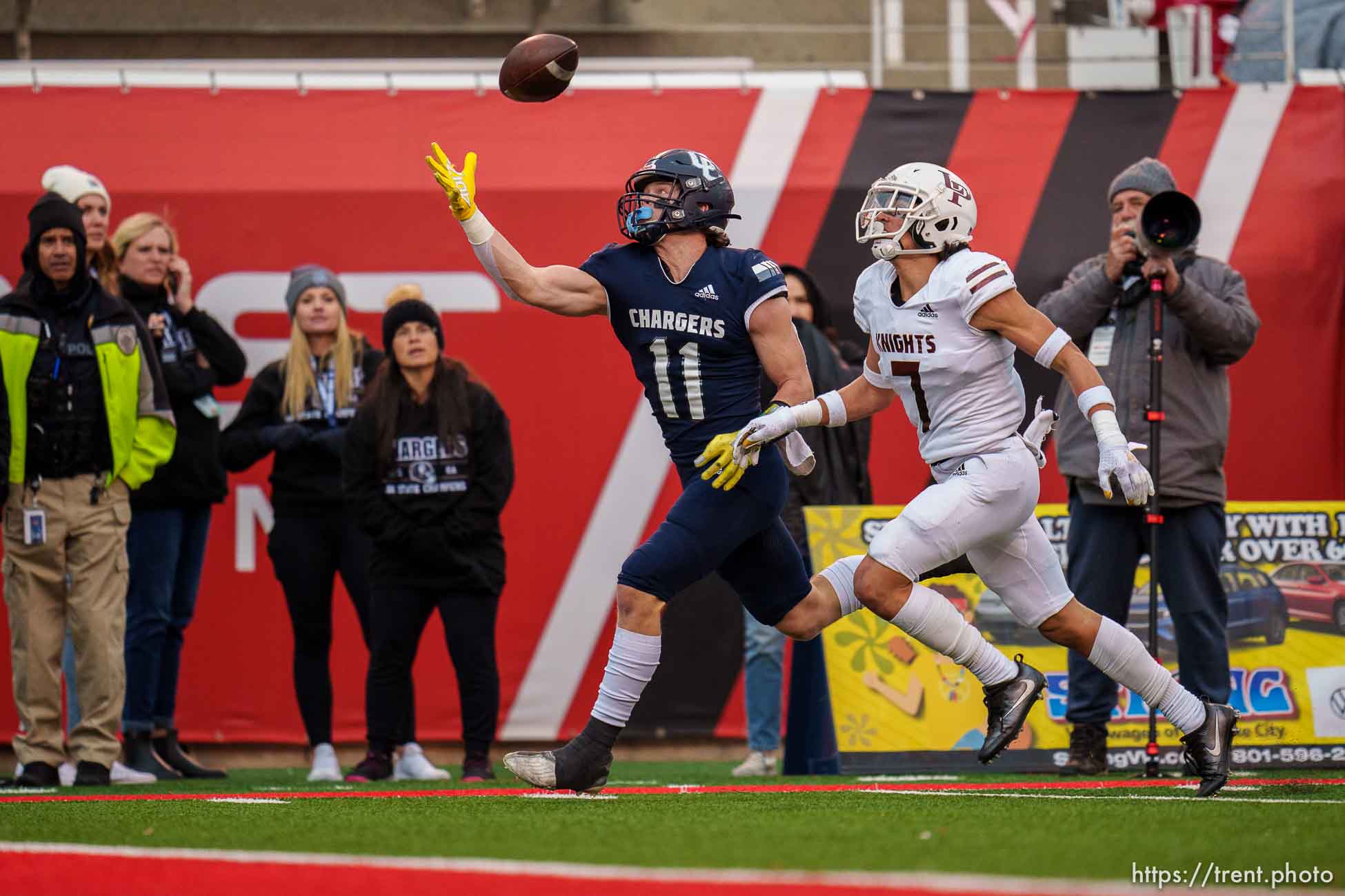 (Trent Nelson  |  The Salt Lake Tribune) Corner Canyon's Jett Meine (11) pulls in a pass one-handed and runs for a touchdown as Lone Peak faces Corner Canyon in the 6A high school football championship game in Salt Lake City on Friday, Nov. 19, 2021. Defending is Lone Peak's Spencer Fotu (7).