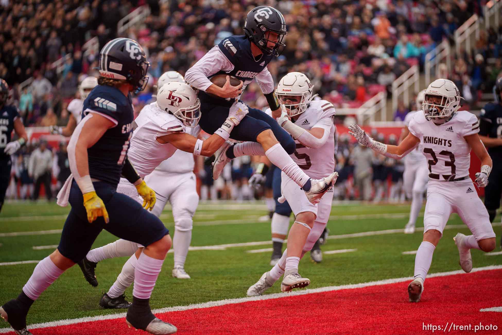 (Trent Nelson  |  The Salt Lake Tribune) Corner Canyon's Devin Brown (15) leaps into the end zone as Lone Peak faces Corner Canyon in the 6A high school football championship game in Salt Lake City on Friday, Nov. 19, 2021.