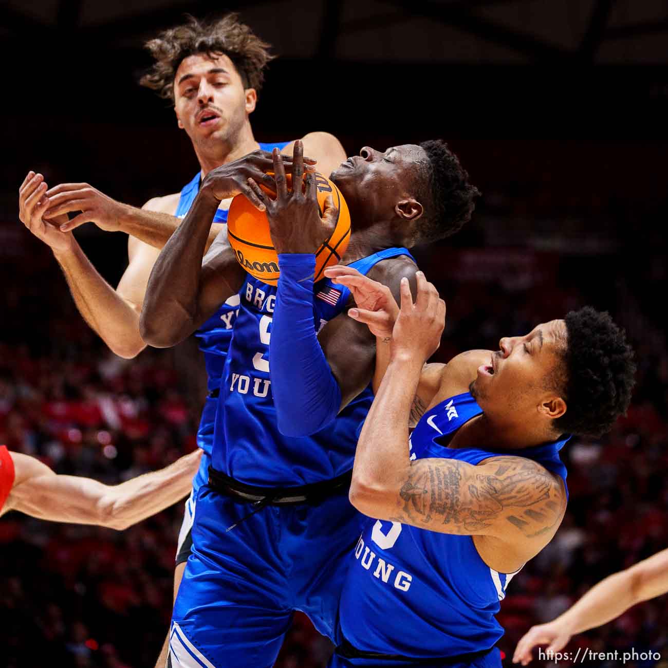 (Trent Nelson  |  The Salt Lake Tribune) Brigham Young Cougars forward Gavin Baxter (51), Brigham Young Cougars forward Gideon George (5), Brigham Young Cougars guard Te'Jon Lucas (3), rebound as the Utah Utes host BYU, NCAA basketball in Salt Lake City on Saturday, Nov. 27, 2021.