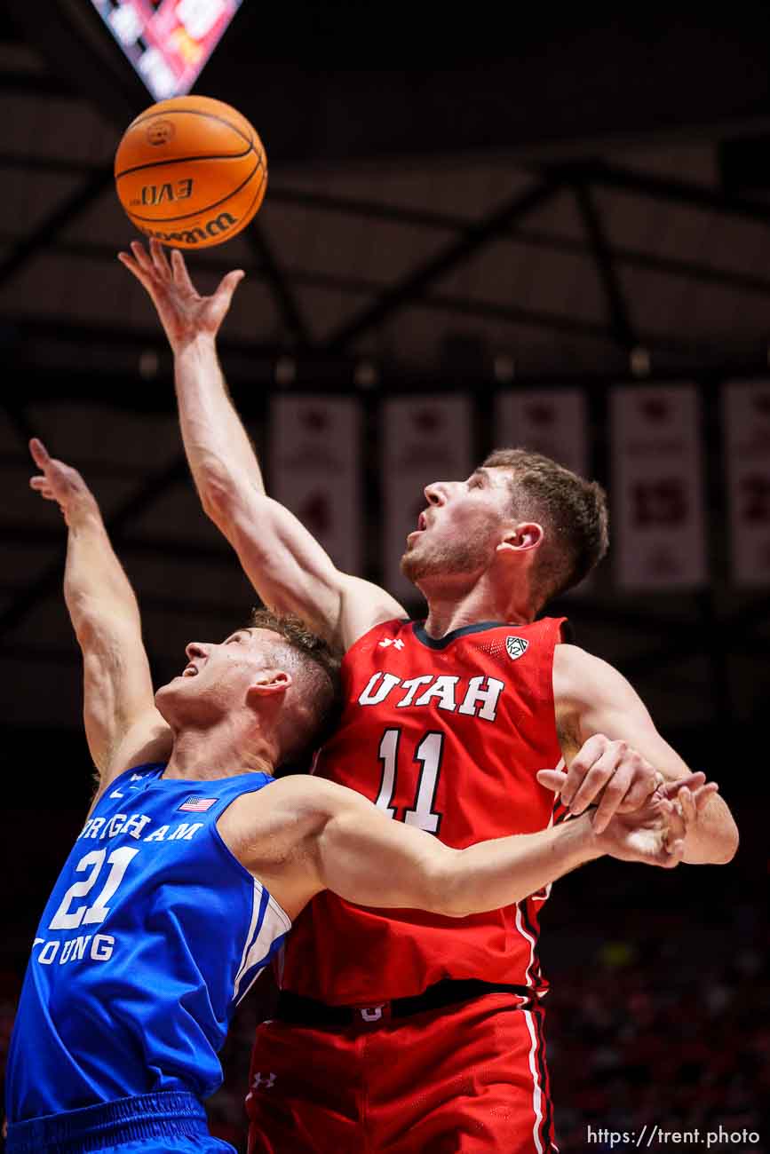 (Trent Nelson  |  The Salt Lake Tribune) Utah Utes forward Riley Battin (11) rebounds over Brigham Young Cougars guard Trevin Knell (21) as the Utah Utes host BYU, NCAA basketball in Salt Lake City on Saturday, Nov. 27, 2021.