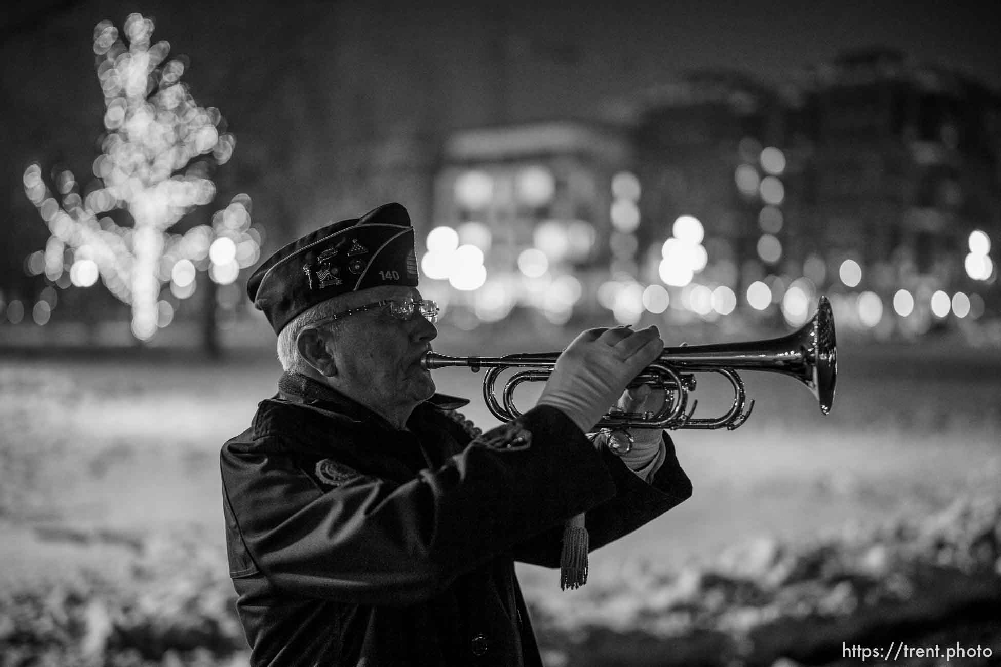 (Trent Nelson  |  The Salt Lake Tribune) Bugler Ron Tranmer plays taps at a vigil for 117 people who died in Salt Lake City while experiencing homelessness in the last year, on Tuesday, Dec. 21, 2021.