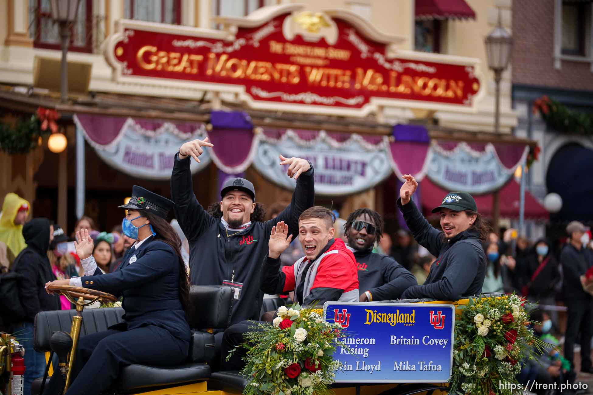 (Trent Nelson  |  The Salt Lake Tribune) Mika Tafua, Devin Lloyd, Britain Covey and Cameron Rising ride down Disneyland's Main Street during the Rose Bowl Game Cavalcade in Anaheim, Calif., on Monday, Dec. 27, 2021.