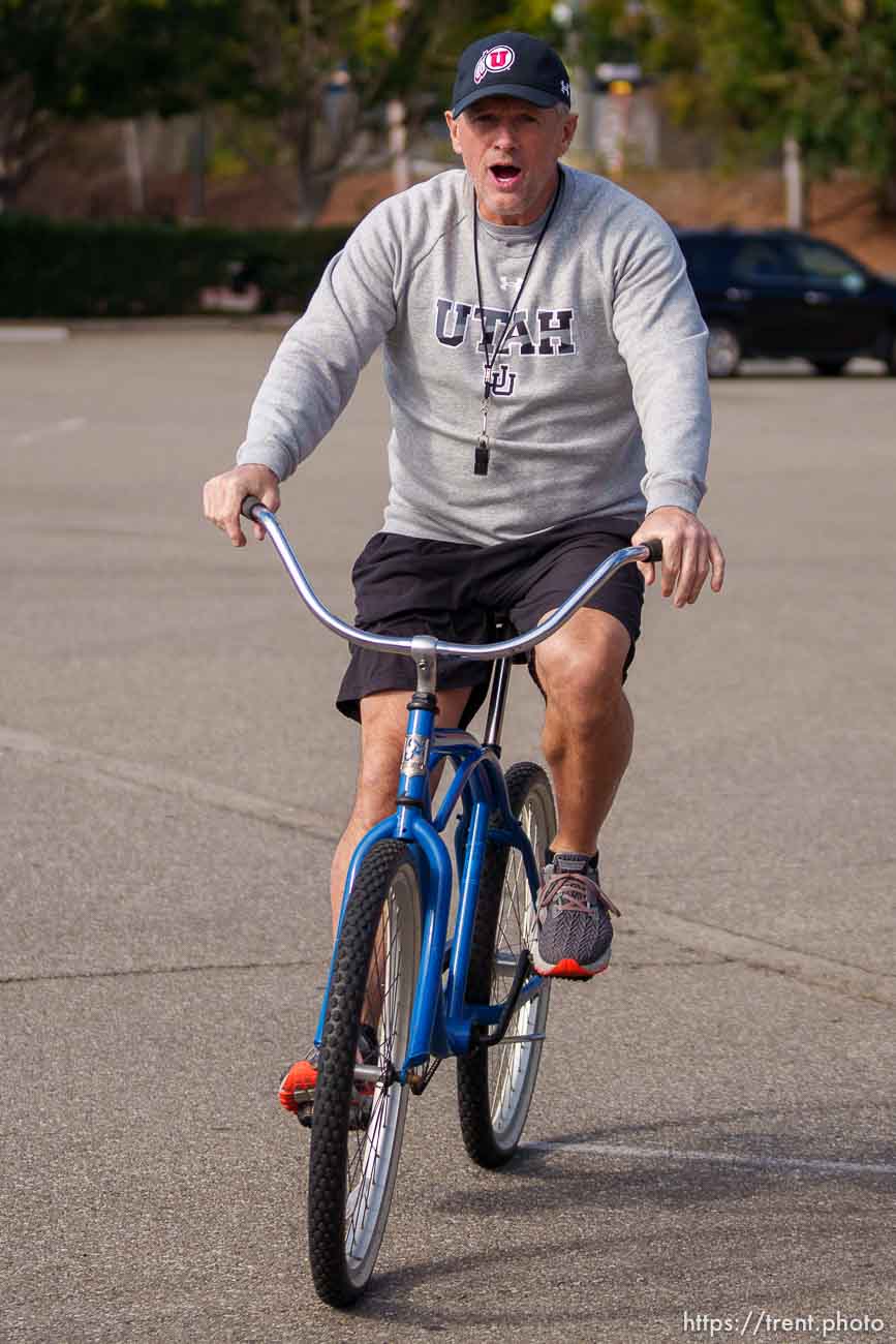 (Trent Nelson  |  The Salt Lake Tribune) Utah football coach Kyle Whittingham arrives on a bike as the University of Utah football team practices for the Rose Bowl at Dignity Health Sports Park in Carson, Calif., on Tuesday, Dec. 28, 2021.