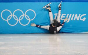 (Trent Nelson  |  The Salt Lake Tribune) Ryan Pivirotto slides into the wall during a qualifying heat for the 1000m, short track speed skating at the 2022 Winter Olympics in Beijing on Saturday, Feb. 5, 2022. After review, Pivirotto was advanced into the quarterfinals.