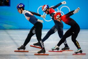 (Trent Nelson  |  The Salt Lake Tribune) Daeheon Hwang (Korea), Sjinkie Knegt, Wenlong Li stretch at the finish line in a qualifying heat for the 1000m, short track speed skating at the 2022 Winter Olympics in Beijing on Saturday, Feb. 5, 2022.