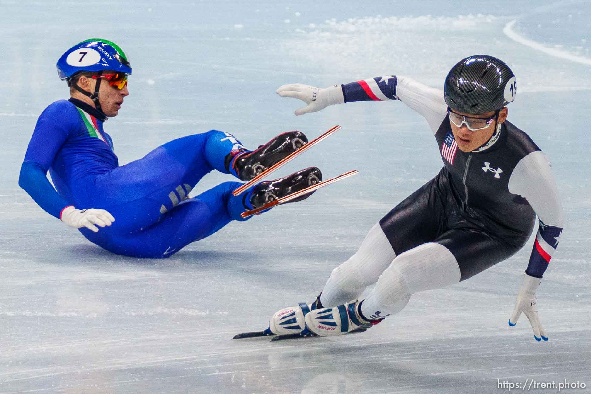 (Trent Nelson  |  The Salt Lake Tribune) Andrew Heo (USA) skates past a fallen Pietro Sighel (Italy) in the 1000m, short track speed skating at the 2022 Winter Olympics in Beijing on Monday, Feb. 7, 2022. At left is Jordan Pierre-Gilles (Canada).