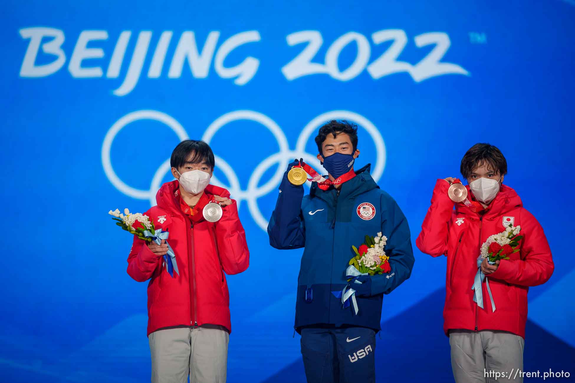 (Trent Nelson  |  The Salt Lake Tribune) Nathan Chen receives his gold medal for men single figure skating at the Beijing Medals Plaza during the 2022 Winter Olympics on Thursday, Feb. 10, 2022. At left is silver medalist Yuma Kagiyama (Japan) and at right is bronze medalist Shoma Uno (Japan).