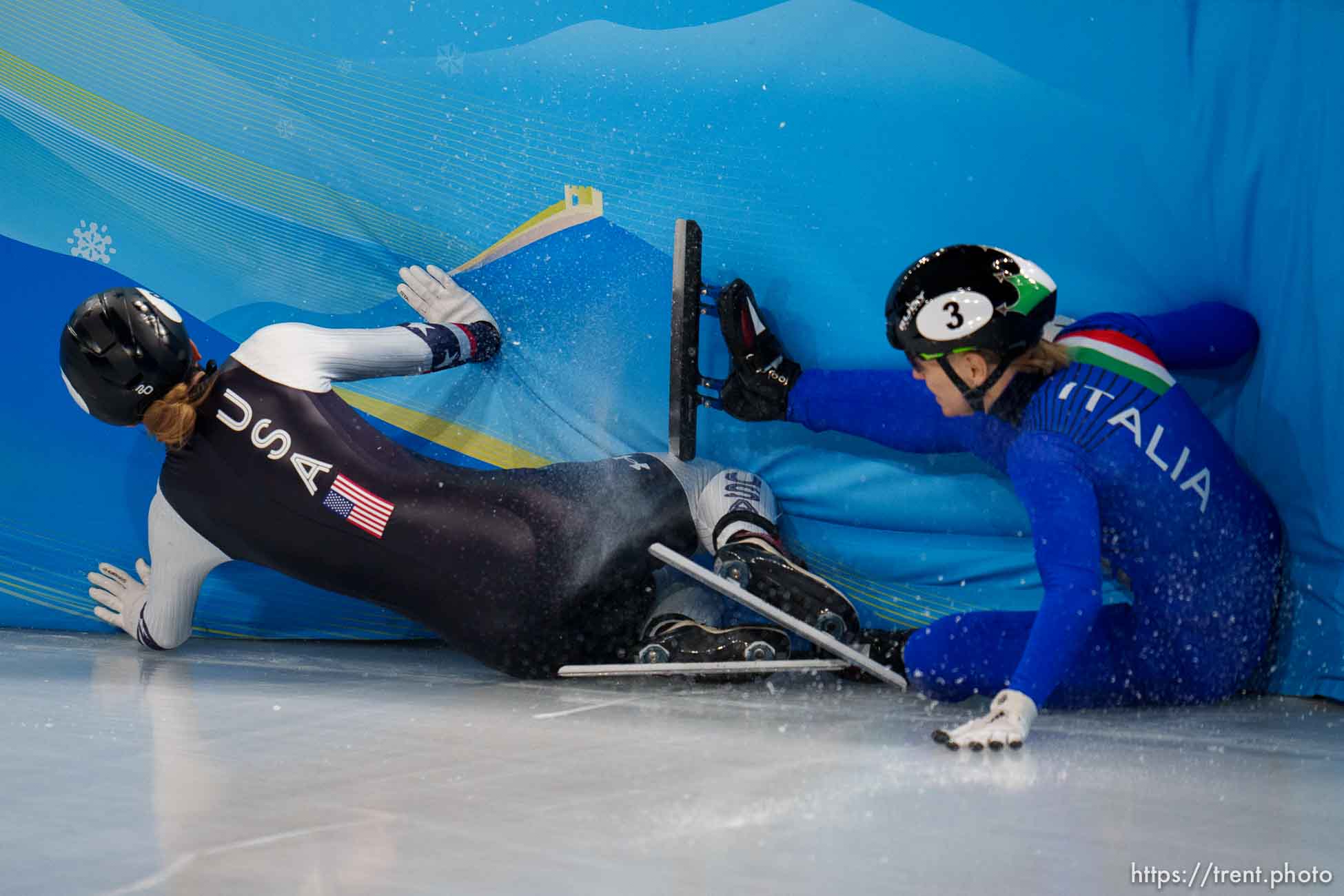 (Trent Nelson  |  The Salt Lake Tribune) Kristen Santos (USA) slides into the wall in the 1000m, short track speed skating at the 2022 Winter Olympics in Beijing on Friday, Feb. 11, 2022. At right is Arianna Fontana (Italy).