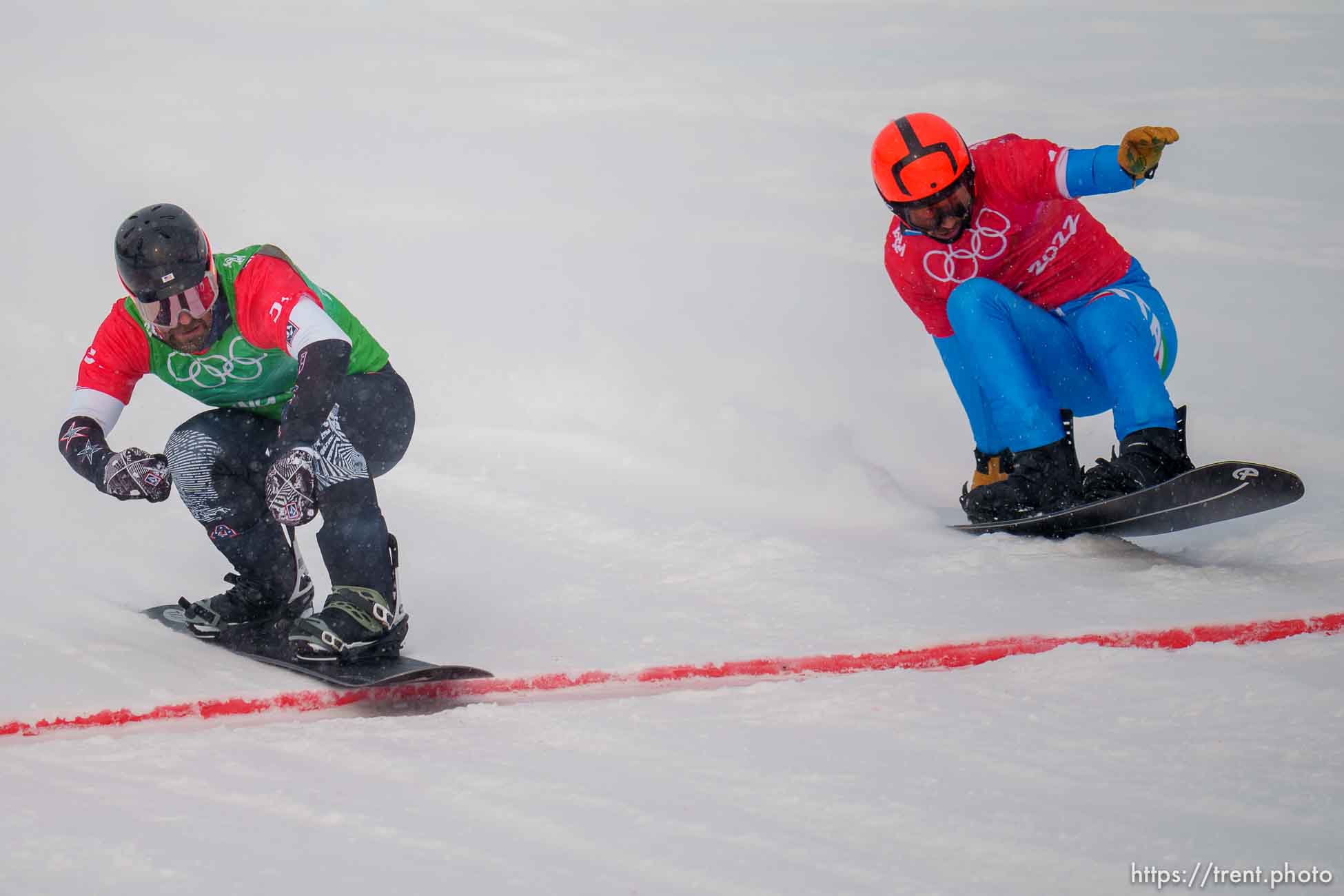 (Trent Nelson  |  The Salt Lake Tribune) Nick Baumgartner (USA) crosses the finish line ahead of Omar Visintin (Italy) at mixed team snowboard cross at the 2022 Beijing Winter Olympics in Zhangjiakou on Saturday, Feb. 12, 2022.