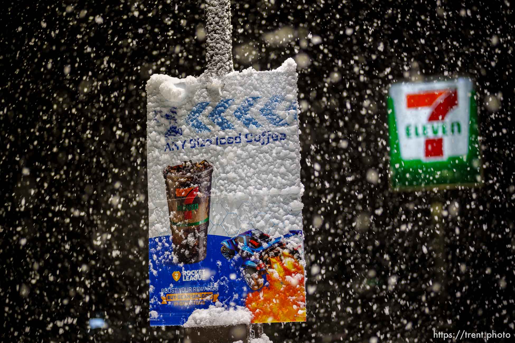 (Trent Nelson  |  The Salt Lake Tribune) Snow falls on a sign advertising iced coffee on Salt Lake City on Saturday, March 5, 2022.