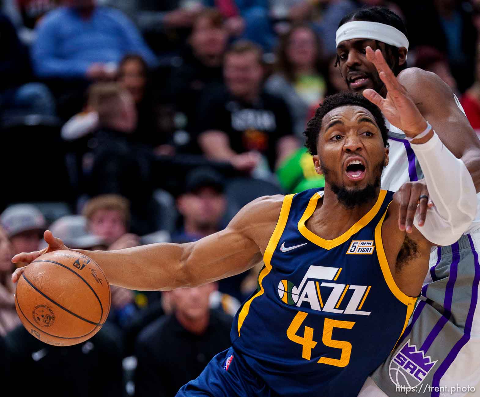 (Trent Nelson  |  The Salt Lake Tribune) Utah Jazz guard Donovan Mitchell (45) drives around Sacramento Kings forward Justin Holiday (9) as the Utah Jazz host the Sacramento Kings, NBA basketball in Salt Lake City on Saturday, March 12, 2022.