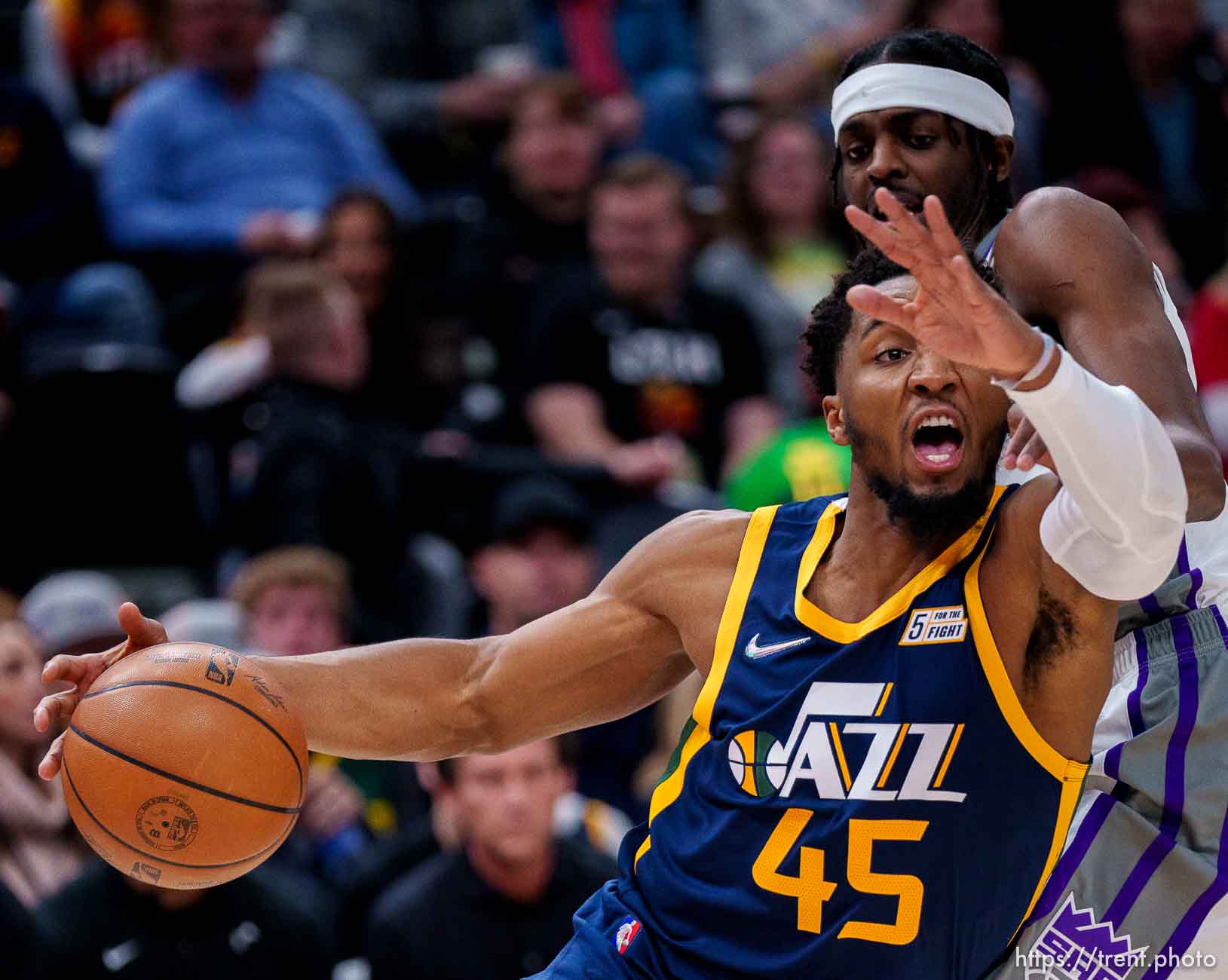 (Trent Nelson  |  The Salt Lake Tribune) Utah Jazz guard Donovan Mitchell (45) drives around Sacramento Kings forward Justin Holiday (9) as the Utah Jazz host the Sacramento Kings, NBA basketball in Salt Lake City on Saturday, March 12, 2022.