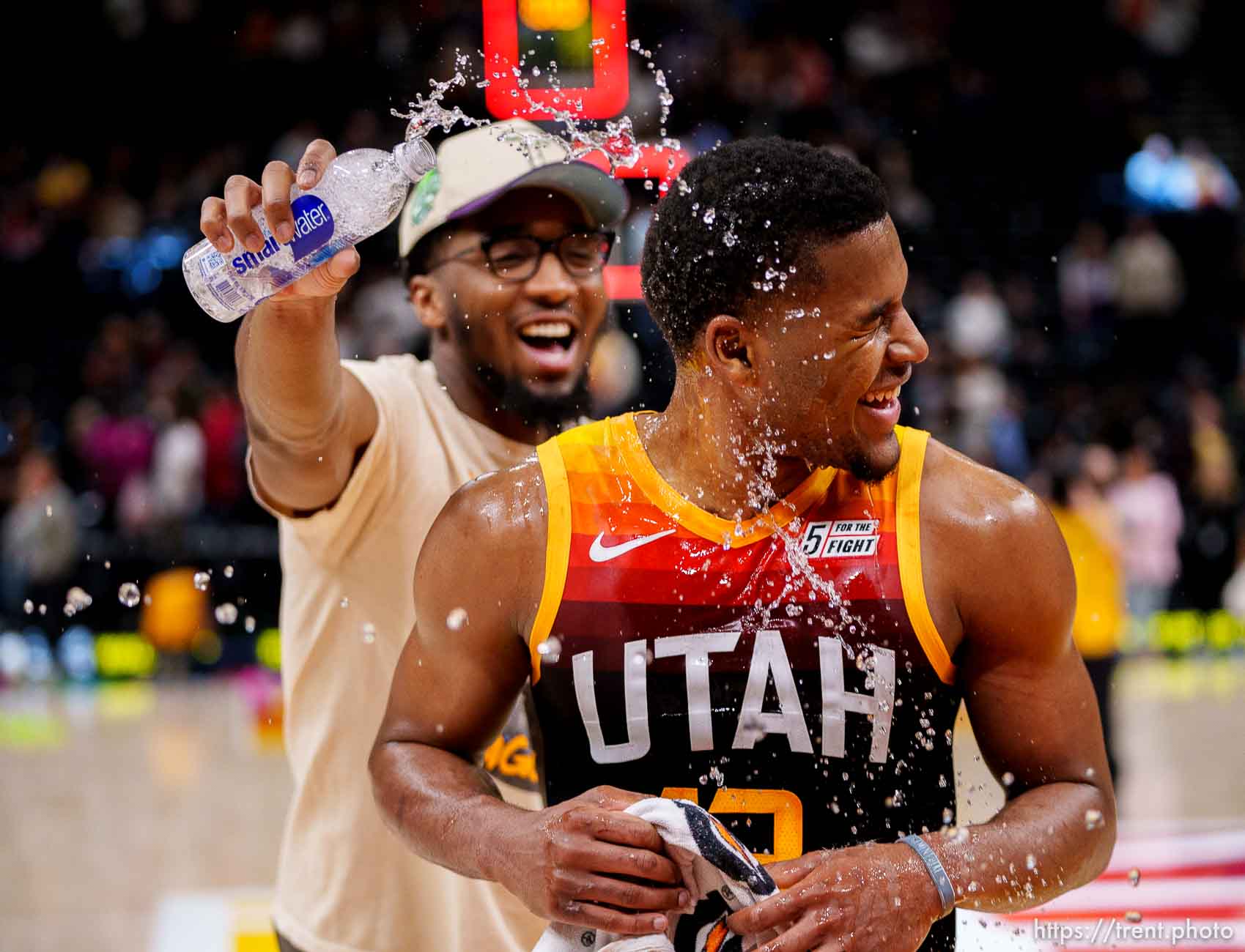 (Trent Nelson  |  The Salt Lake Tribune) Utah Jazz guard Jared Butler (13) gets doused by Utah Jazz guard Donovan Mitchell (45) as the Utah Jazz host the Los Angeles Clippers, NBA basketball in Salt Lake City on Friday, March 18, 2022.