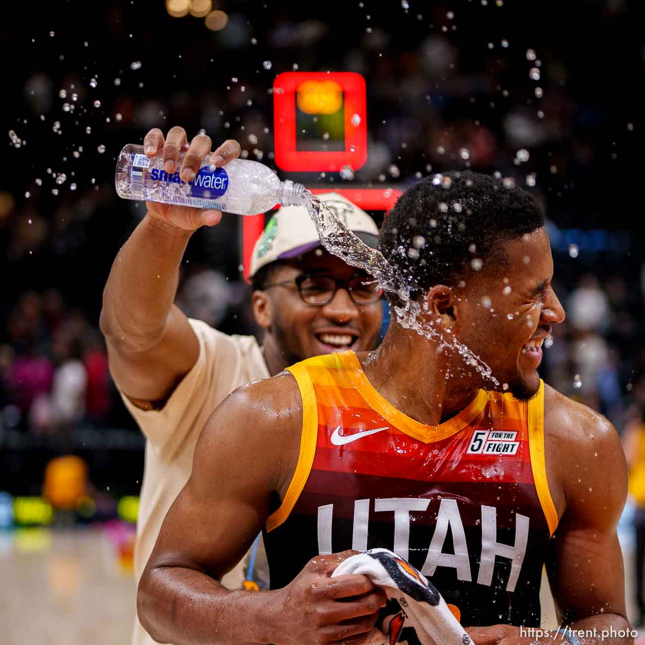 (Trent Nelson  |  The Salt Lake Tribune) Utah Jazz guard Jared Butler (13) gets doused by Utah Jazz guard Donovan Mitchell (45) as the Utah Jazz host the Los Angeles Clippers, NBA basketball in Salt Lake City on Friday, March 18, 2022.