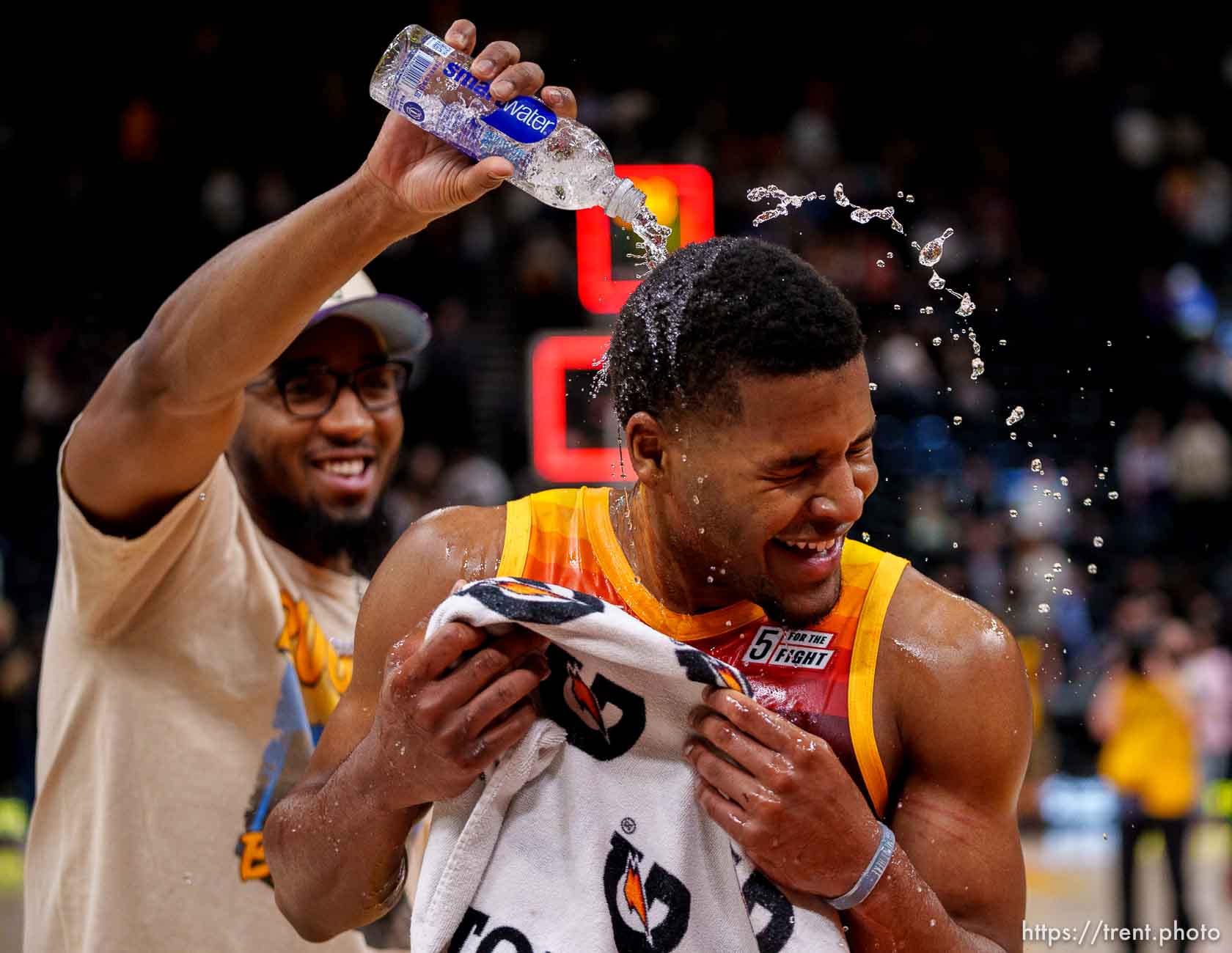 (Trent Nelson  |  The Salt Lake Tribune) Utah Jazz guard Jared Butler (13) gets doused by Utah Jazz guard Donovan Mitchell (45) as the Utah Jazz host the Los Angeles Clippers, NBA basketball in Salt Lake City on Friday, March 18, 2022.