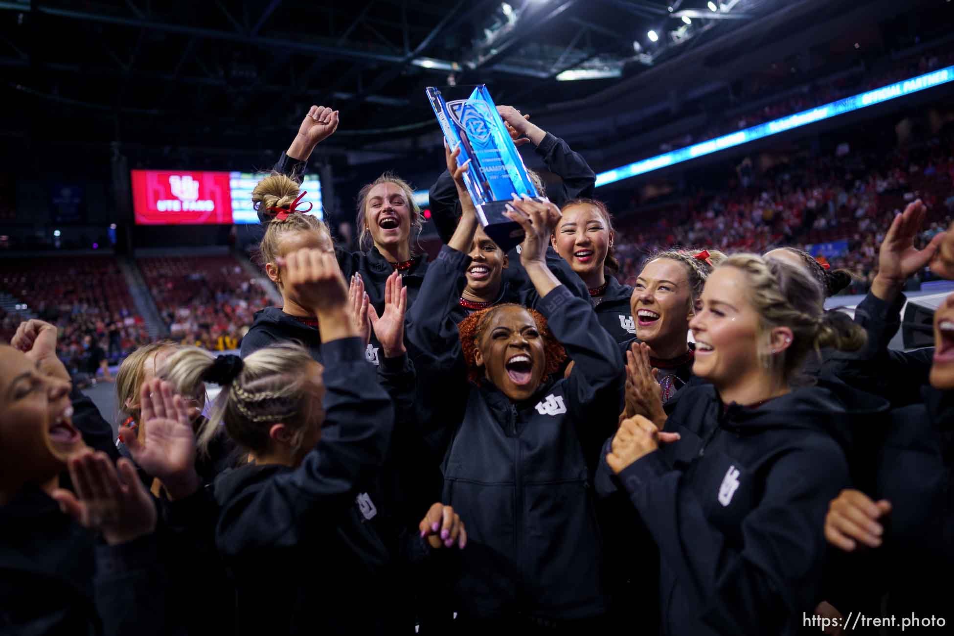 (Trent Nelson  |  The Salt Lake Tribune) Utah celebrates with the Pac-12 championship trophy at the Pac-12 gymnastics championships at the Maverik Center in West Valley City on Saturday, March 19, 2022.