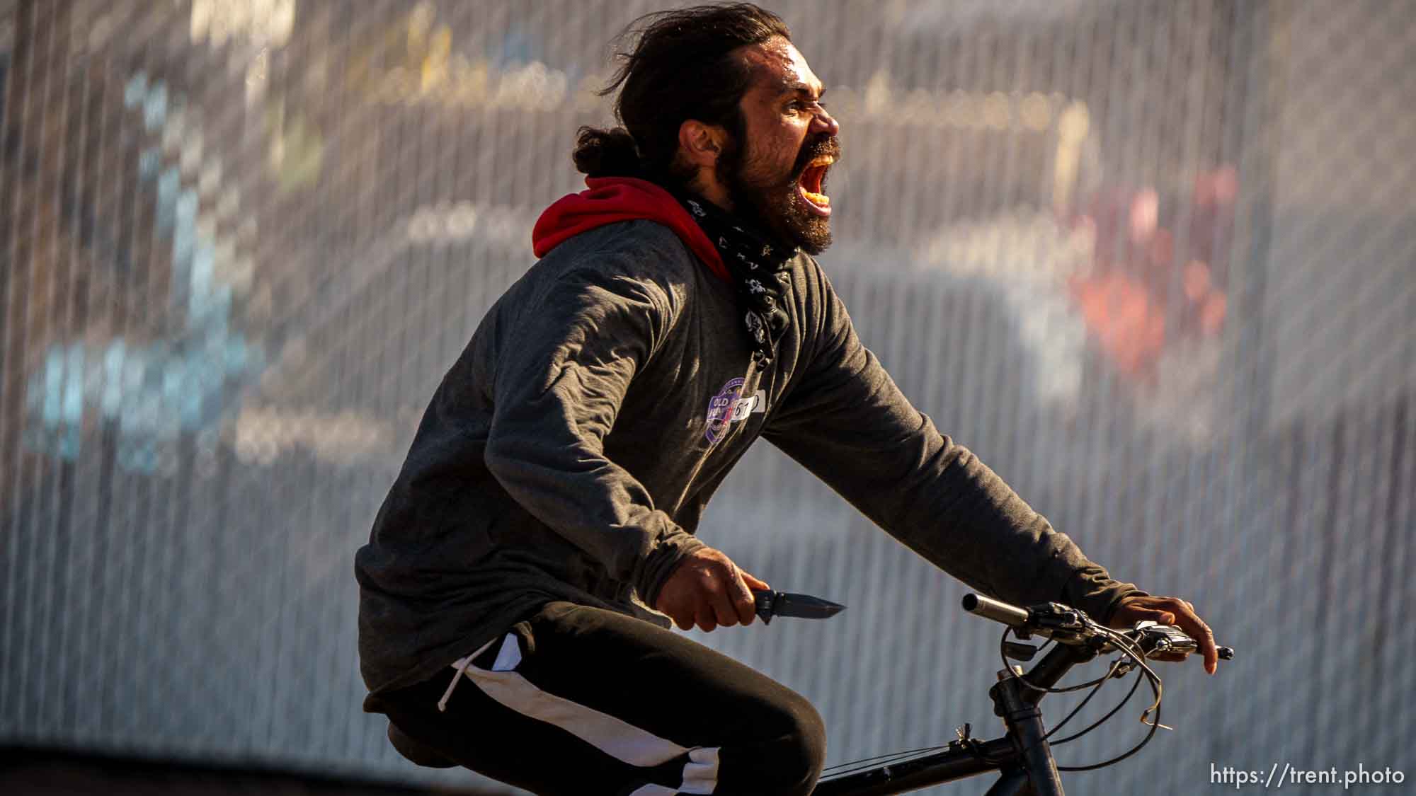 guy riding bike down 1700 south with a knife on Thursday, March 17, 2022.