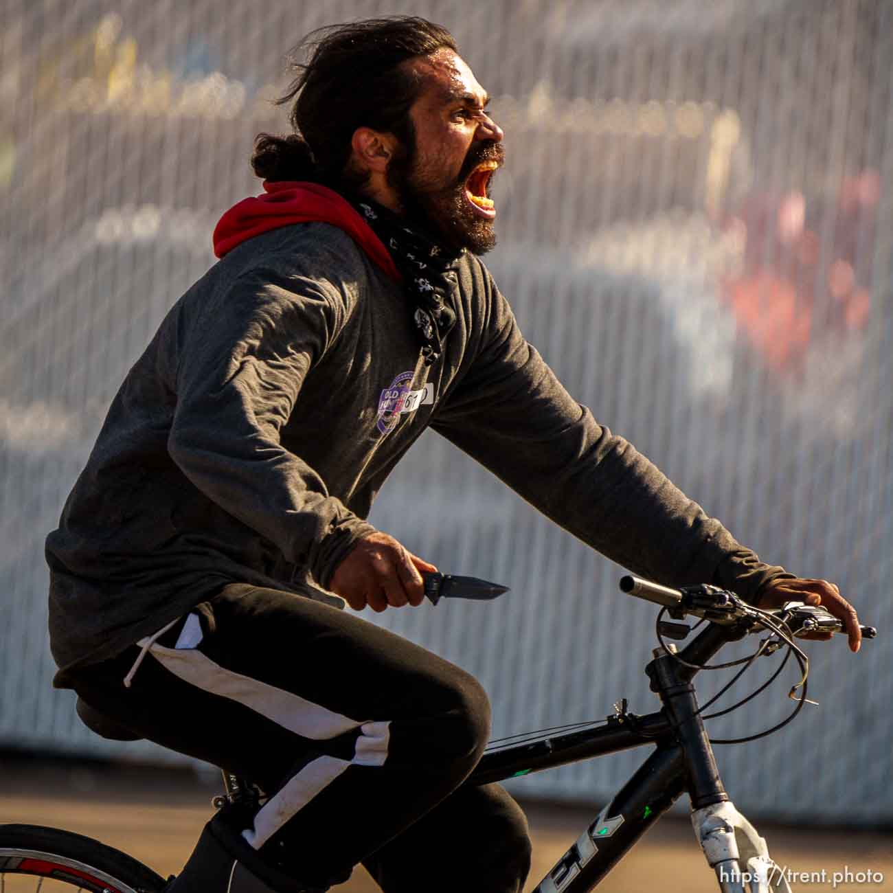 guy riding bike down 1700 south with a knife on Thursday, March 17, 2022.