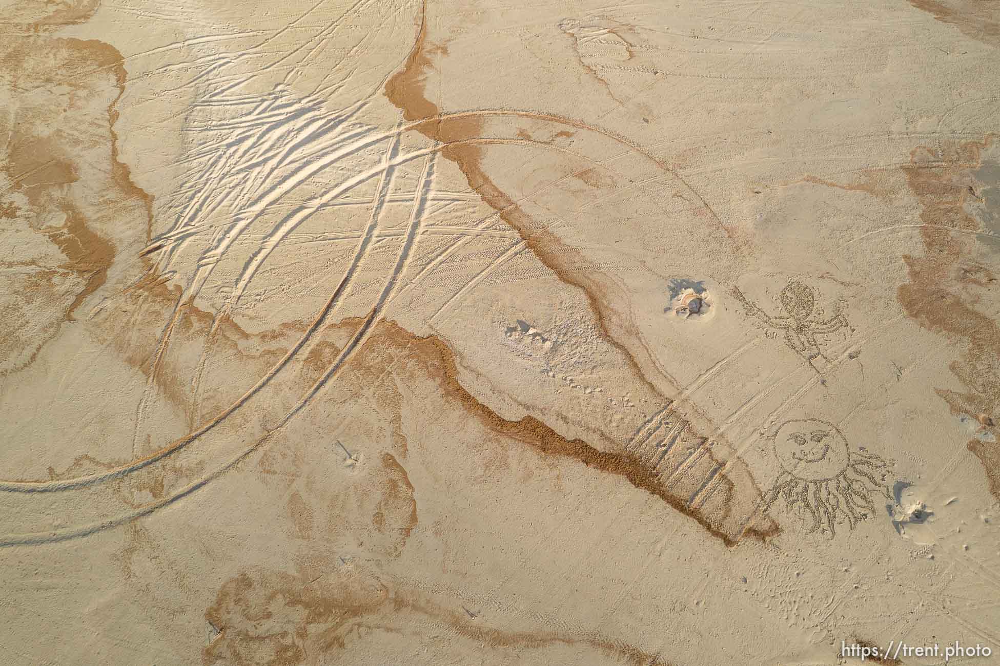 (Trent Nelson  |  The Salt Lake Tribune) Sand art and tire tracks along the shore of the Great Salt Lake at Stansbury Island on Saturday, March 26, 2022.