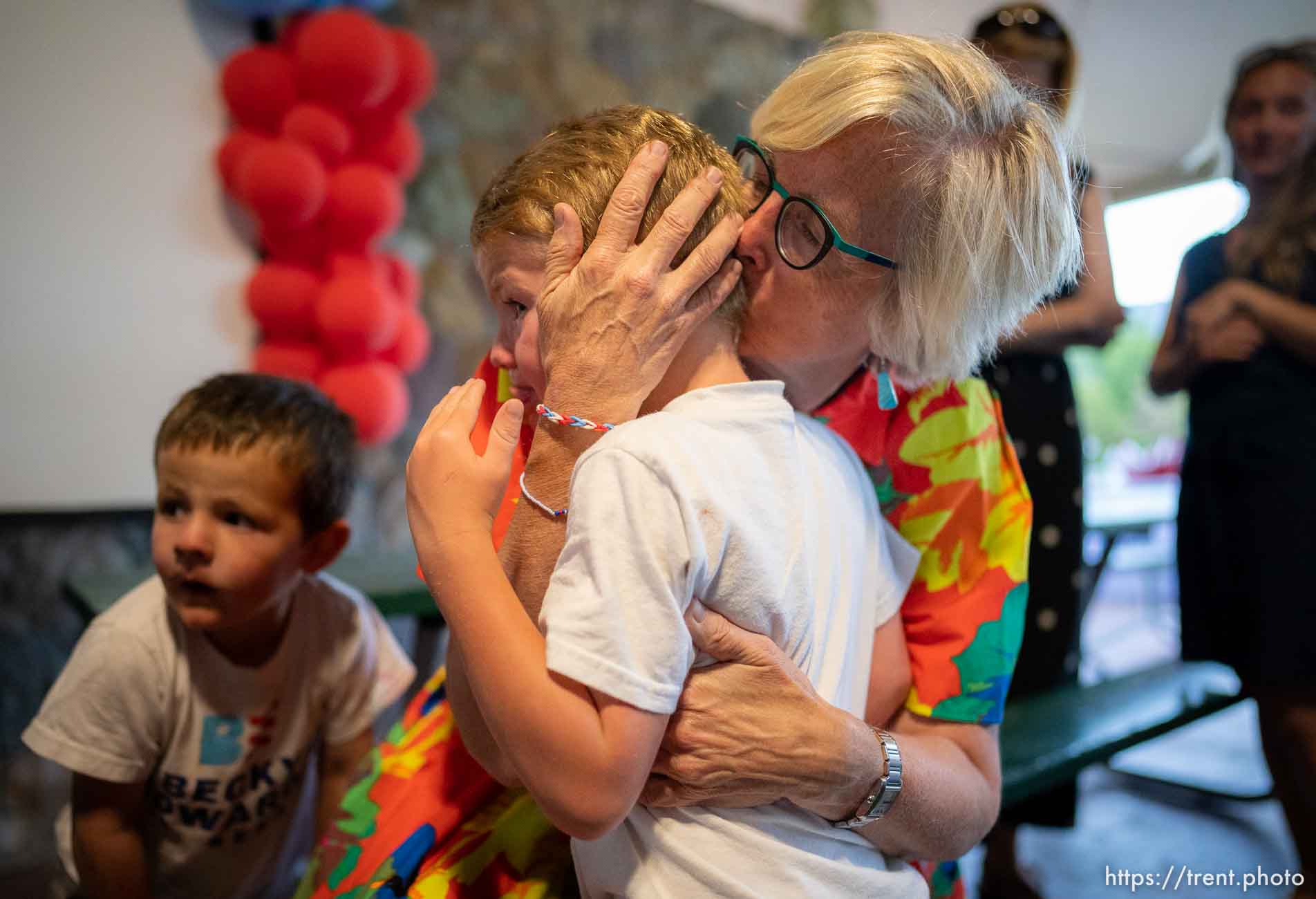 (Trent Nelson  |  The Salt Lake Tribune) Republican U.S. Senate candidate Becky Edwards comforts her grandchild John Jensen at her primary election night party in Salt Lake City's Sugar House Park on Tuesday, June 28, 2022. At left is another grandchild, Alvin Jensen.