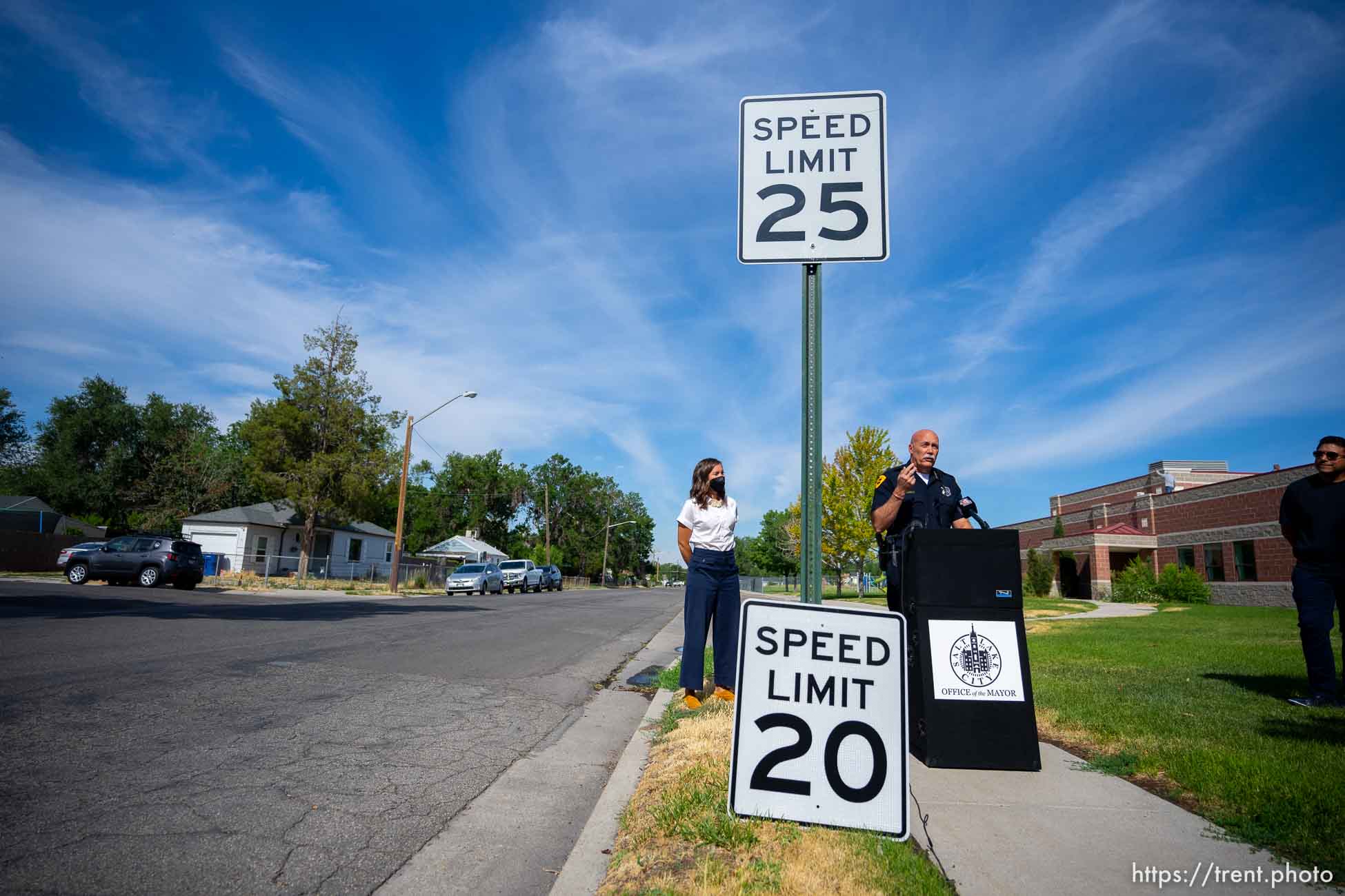 (Trent Nelson  |  The Salt Lake Tribune) Mayor Erin Mendenhall and Police Chief Mike Brown prepare to swap out a 25 mph speed limit sign for a new 20 mph sign, in Salt Lake City on Wednesday, July 27, 2022. At right is city council member Alejandro Puy.