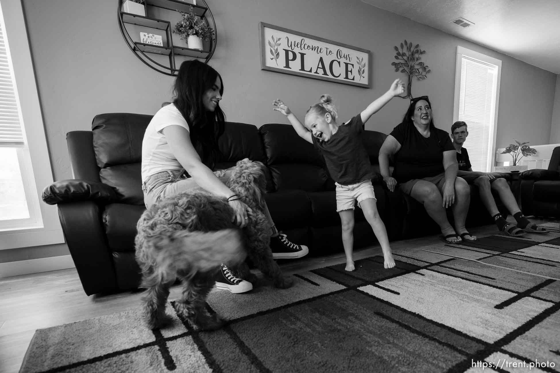 (Trent Nelson  |  The Salt Lake Tribune) Shinia Allred, left, visits with Jana Woodbury in one of Allred's Airbnb properties in Castle Dale on Monday, Aug. 8, 2022. Woodbury and her family had rented the home for a weekend. From left, Shinia Allred, Chloe (dog), Sophia Allred, Jana Woodbury, and Gage Woodbury.