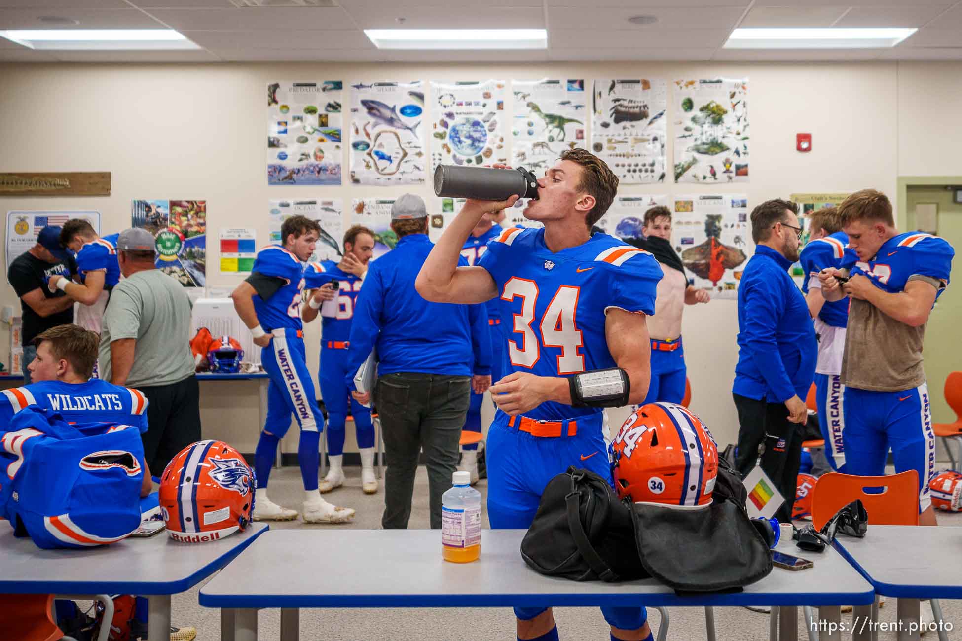 (Trent Nelson  |  The Salt Lake Tribune) Water Canyon High School football players suit up and hydrate in a biology classroom before their first game, against Grand County, in Hildale on Friday, Aug. 12, 2022.