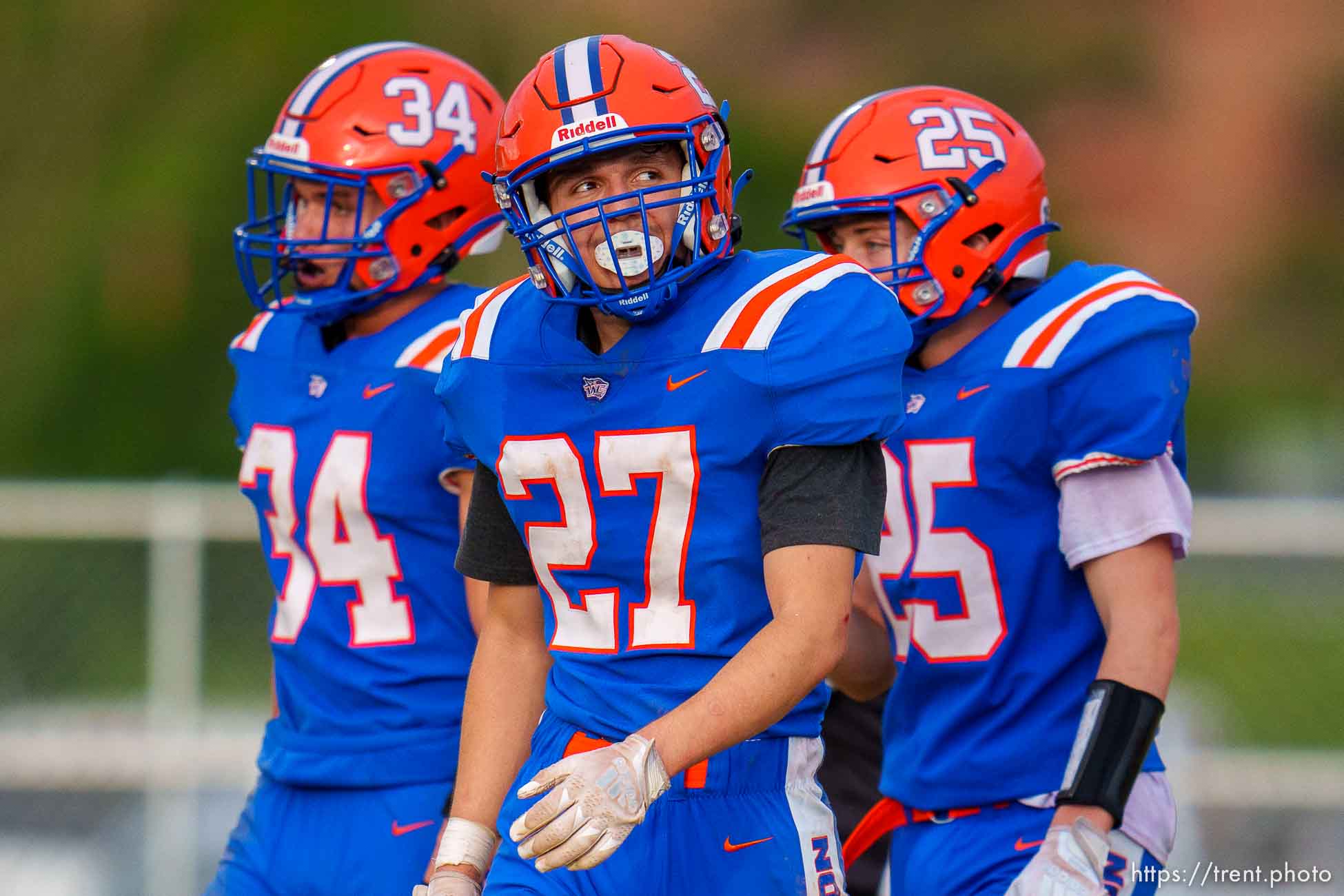 (Trent Nelson  |  The Salt Lake Tribune) Water Canyon High School players look to the scoreboard after a Ground County touchdown, in Hildale on Friday, Aug. 12, 2022. From left are Collin Kelsch, Kyler Dockstader, and David Barlow.