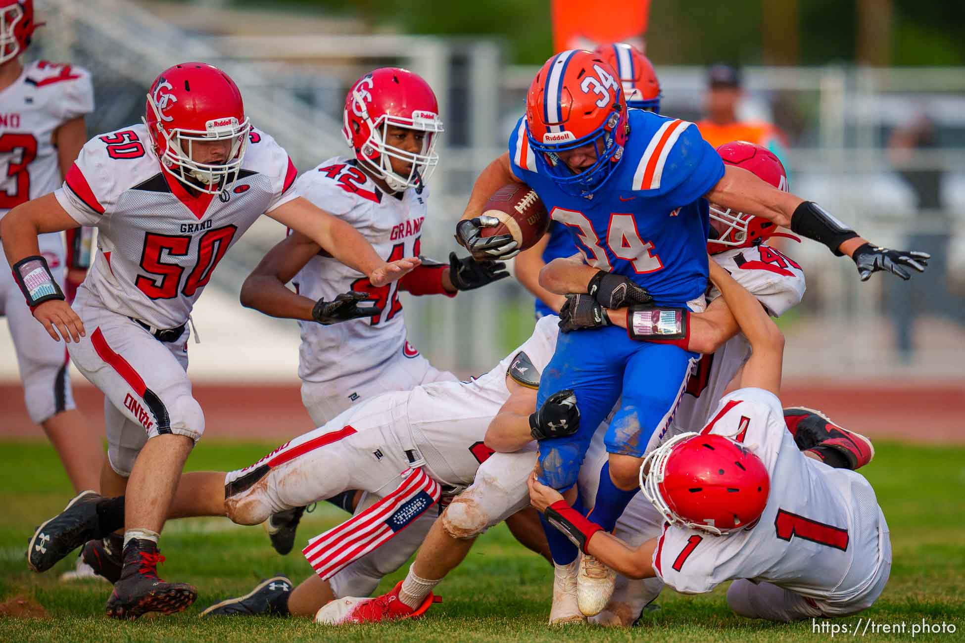 (Trent Nelson  |  The Salt Lake Tribune) Water Canyon High School's Collin Kelsch is brought down by a swarm of Grand County defenders in Hildale on Friday, Aug. 12, 2022.