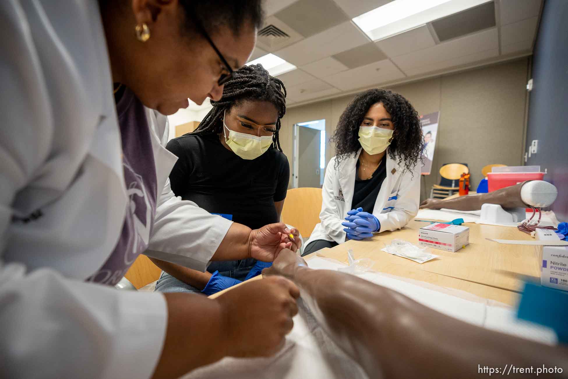 (Trent Nelson  |  The Salt Lake Tribune) Alice Akunyili, left, demonstrates starting an IV at the first ever Medicine Immersion Day at Alta View Hospital in Sandy on Saturday, Sept. 24, 2022. Intermountain Healthcare and Black Physicians of Utah put on the event to benefit students of color from communities across the state.