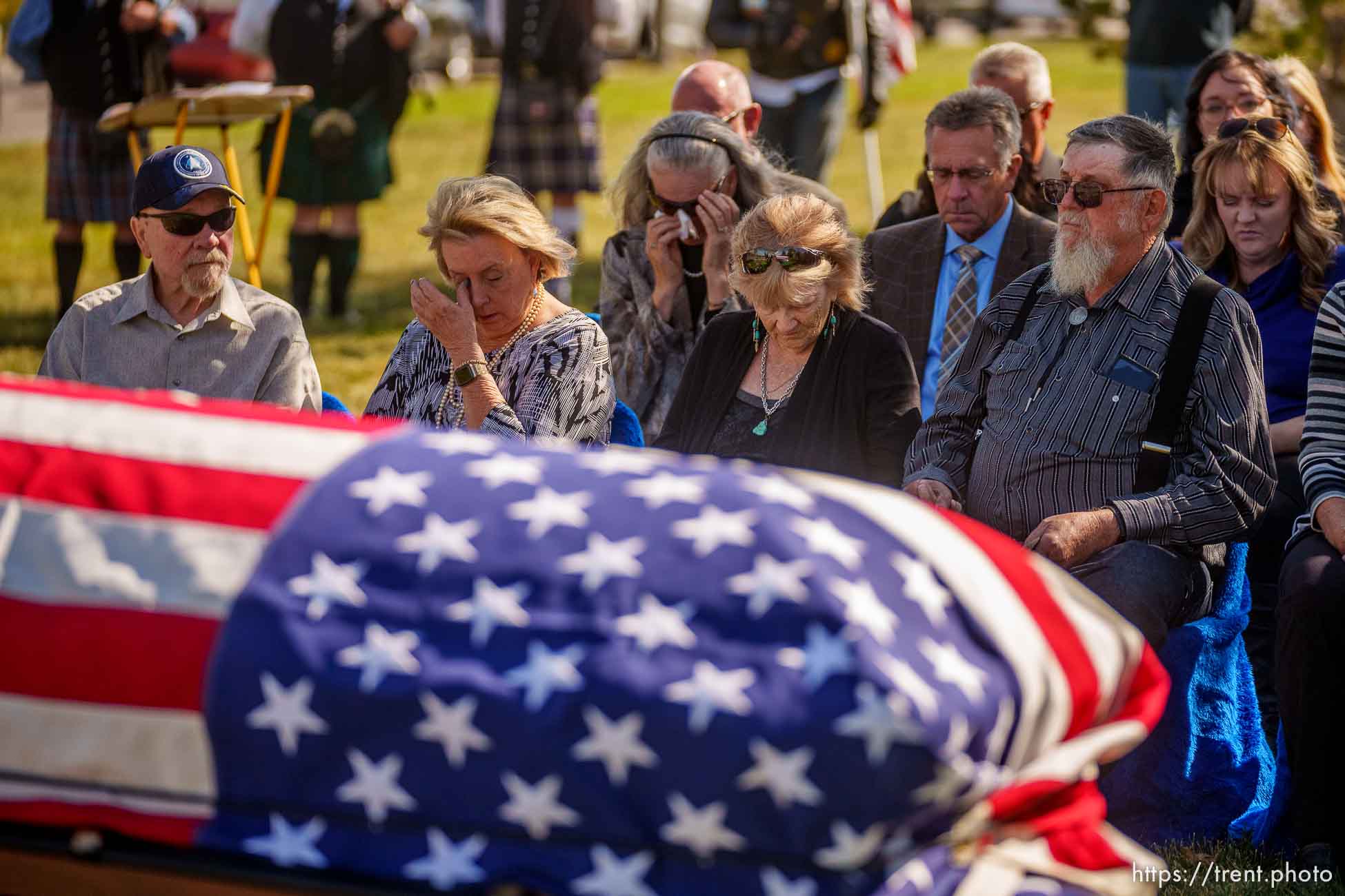 (Trent Nelson  |  The Salt Lake Tribune)  Sgt. Elvin Lee Phillips is laid to rest at Utah Veteran’s Cemetery and Memorial Park in Bluffdale on Tuesday, Oct. 11, 2022, almost 80 years after he was killed in action during World War II. From left are family members Frank Moe, Kristie Moe, Kayce Phillips, and Joe Phillips.