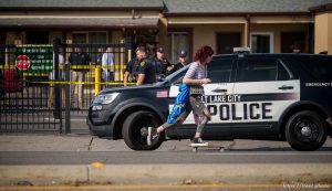 (Trent Nelson  |  The Salt Lake Tribune) Police at the scene of a shooting at Wasatch Inn, on State Street in the Ballpark neighborhood of Salt Lake City on Tuesday, Oct. 11, 2022.