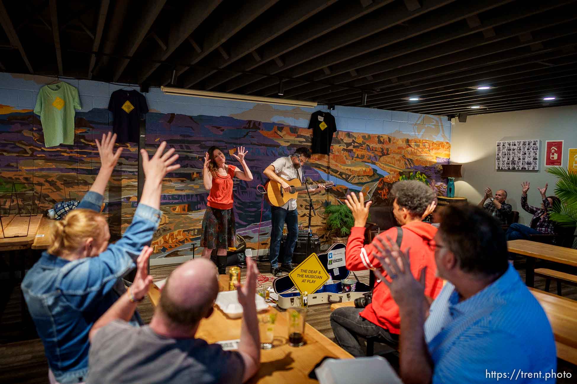 (Trent Nelson  |  The Salt Lake Tribune) The audience applauds in American Sign Language as Cindy McAllister and Ben Brinton, The Deaf & The Musician, perform at RoHa Brewing Project in Salt Lake City on Thursday, Oct. 13, 2022.