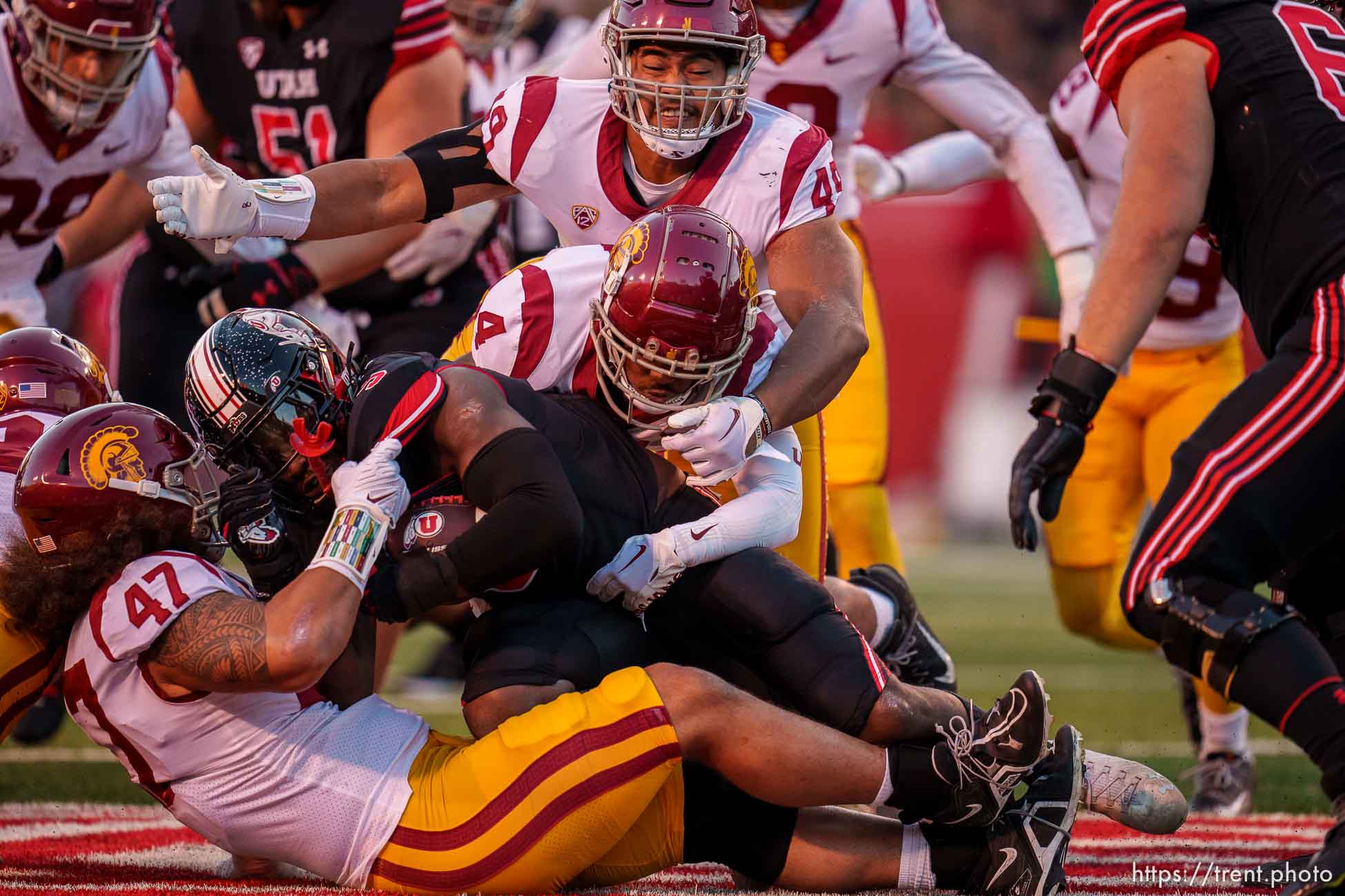 (Trent Nelson  |  The Salt Lake Tribune) USC defenders bring down Utah Utes running back Tavion Thomas (9) as the University of Utah hosts USC, NCAA football in Salt Lake City on Saturday, Oct. 15, 2022.