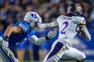 (Trent Nelson  |  The Salt Lake Tribune) East Carolina Pirates running back Keaton Mitchell (2) runs from Brigham Young Cougars linebacker Ben Bywater (2) as BYU hosts East Carolina, NCAA football in Provo on Friday, Oct. 28, 2022.