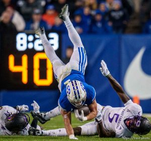 (Trent Nelson  |  The Salt Lake Tribune) Brigham Young Cougars running back Lopini Katoa (4) leaps over defenders as BYU hosts East Carolina, NCAA football in Provo on Friday, Oct. 28, 2022.