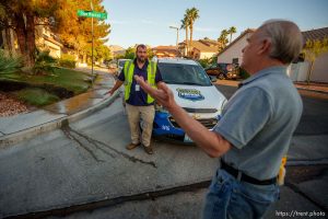 (Trent Nelson  |  The Salt Lake Tribune) Homeowner Guido Huizing, right, speaks with Salvador Polanco-Gamez, a conservation aide with the Las Vegas Valley Water District, on patrol in Summerlin, a community in the Las Vegas Valley, Nevada on Thursday, Sept. 29, 2022. When runoff water from a home's sprinklers reaches the street, Polanco-Gamez stops to document the situation and notify the homeowner.