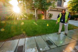 (Trent Nelson  |  The Salt Lake Tribune) Salvador Polanco-Gamez, a conservation aide with the Las Vegas Valley Water District, documents a leak in a sprinkler system in Summerlin, a community in the Las Vegas Valley, Nevada on Thursday, Sept. 29, 2022.