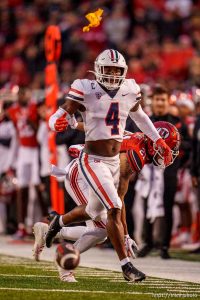 (Trent Nelson  |  The Salt Lake Tribune) A flag flies through the air as Arizona Wildcats cornerback Christian Roland-Wallace (4) defends a pass to Utah Utes wide receiver Solomon Enis (21) as the University of Utah hosts Arizona, NCAA football in Salt Lake City on Saturday, Nov. 5, 2022.