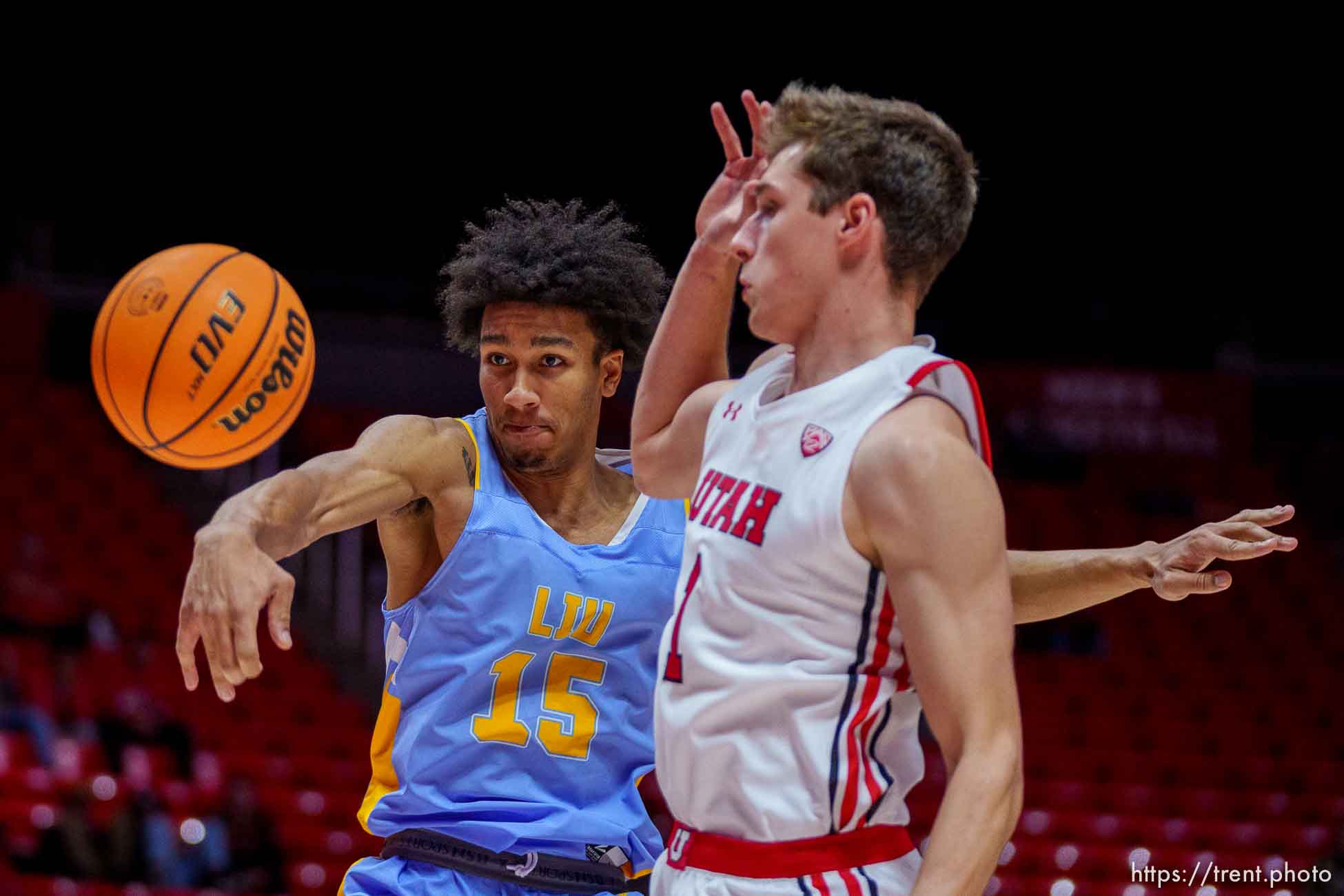 (Trent Nelson  |  The Salt Lake Tribune) Long Island University Sharks center C.J. Delancy knocks the ball from Utah Utes forward Ben Carlson (1) as the University of Utah hosts Long Island University, NCAA basketball in Salt Lake City on Monday, Nov. 7, 2022.